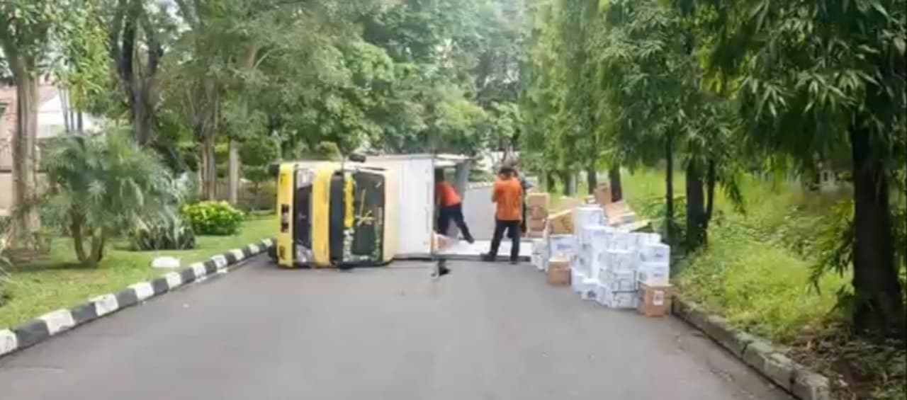 Tabrak Pembatas Jalan, Truk Muat Air Mineral Terguling di Sukomanunggal Jaya